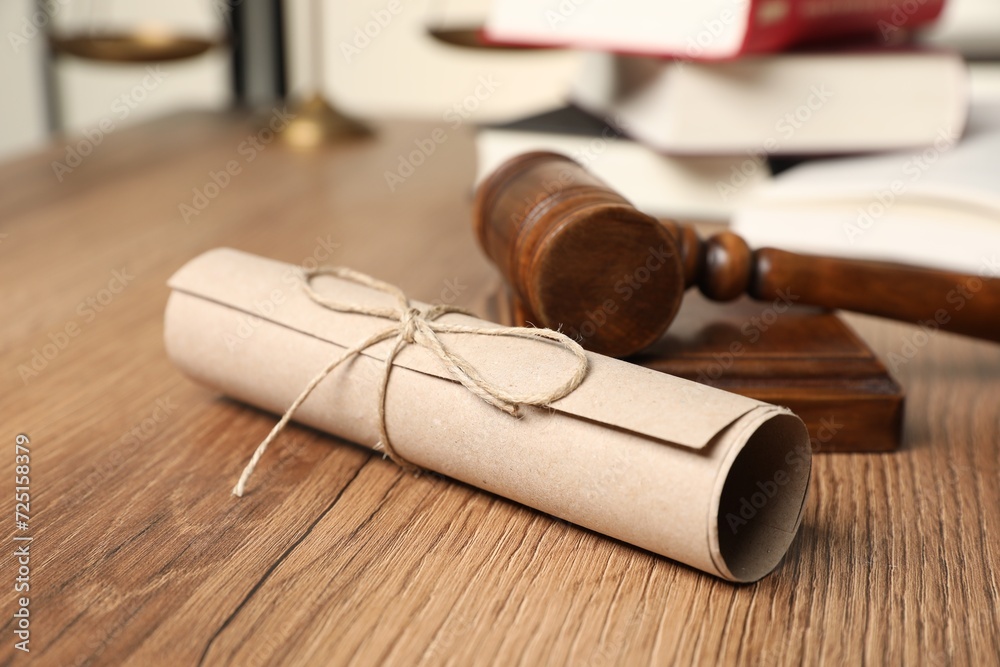 Document and gavel on wooden table, closeup. Notary contract
