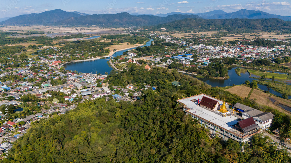 Aerial view of Wat Phra That Chom Chor with view of Wiang Thoeng town an iconic ancient pagoda on the small hill in Thoeng district of Chiang Rai province Thailand. 
