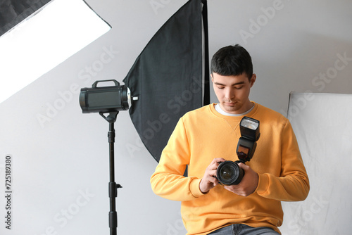 Young male photographer wit...