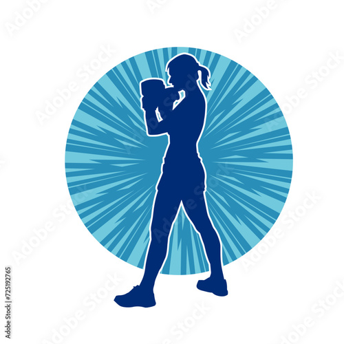 Silhouette of woman boxing athlete in action pose. Silhouette of a female wearing boxing gloves for boxing sport.