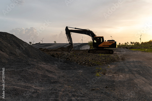 Development in progress, excavator on a construction site photo