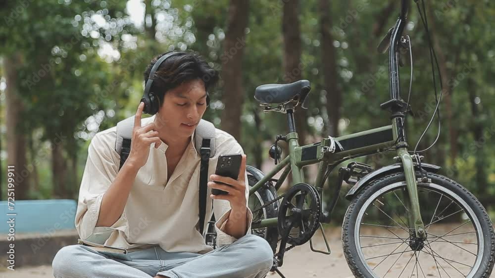 Man enjoying music using earphones while commuting to office on a bicycle. Businessman biking to office while listening to music. Man enjoying music using earphones while commuting to office on a bicycle. Businessman biking to office while listening to music.