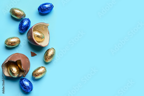 Chocolate Easter eggs in foil on blue background