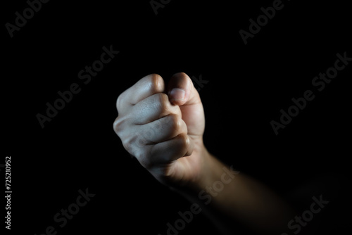 fist, Hand gesture. man clenched fist, ready to punch, isolated on black, close-up, copy space photo