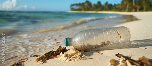 Beach pollution caused by plastic bottle endangering the environment and ocean.