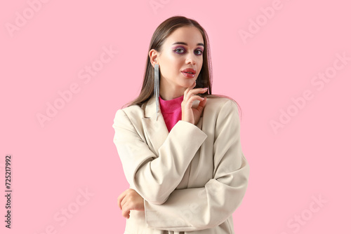 Stylish young woman on pink...