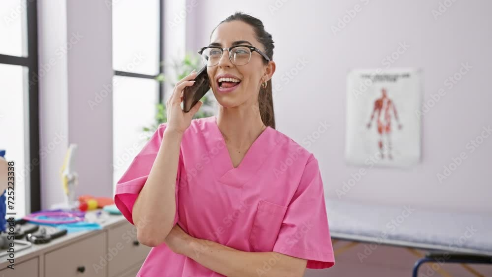 Young and beautiful hispanic woman smiling - a portrait of a confident therapist at work, engaging in a heartening conversation via smartphone at a bustling rehab clinic Young and beautiful hispanic woman smiling - a portrait of a confident therapist at work, engaging in a heartening conversation via smartphone at a bustling rehab clinic