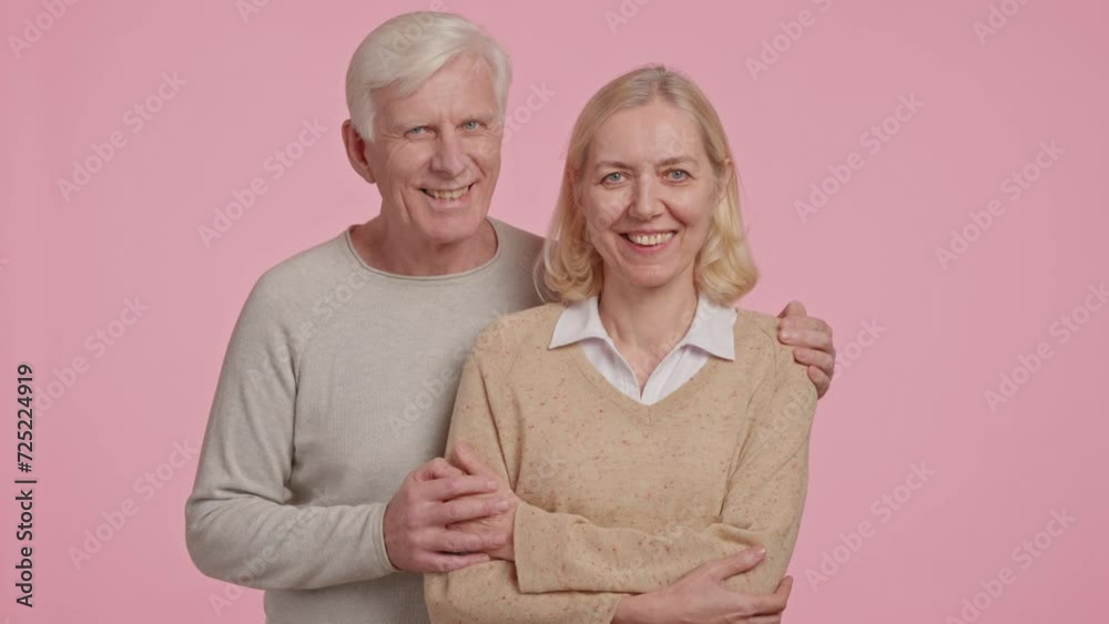 happy adult married couple posing looking at the camera happy adult married couple posing looking at the camera