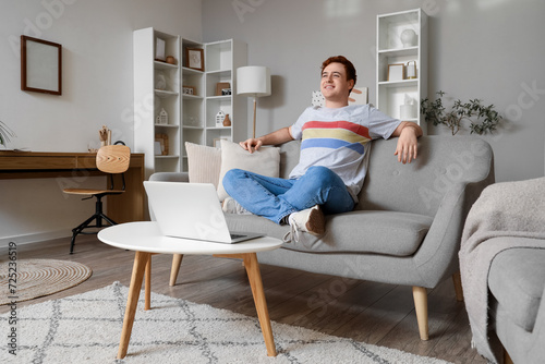 Relaxed young man sitting o...