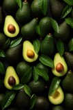 Avocado fruit with leaves on black background. Top view. Flat lay.