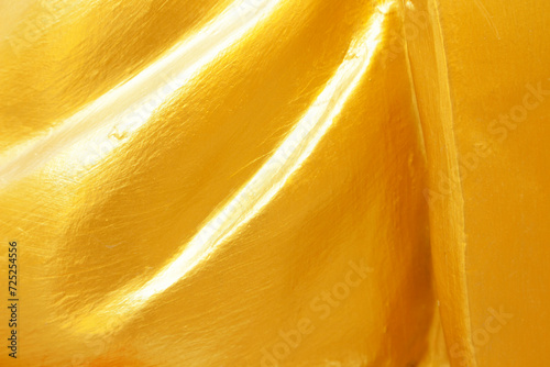 Gold or yellow paint on cement wall texture  background.