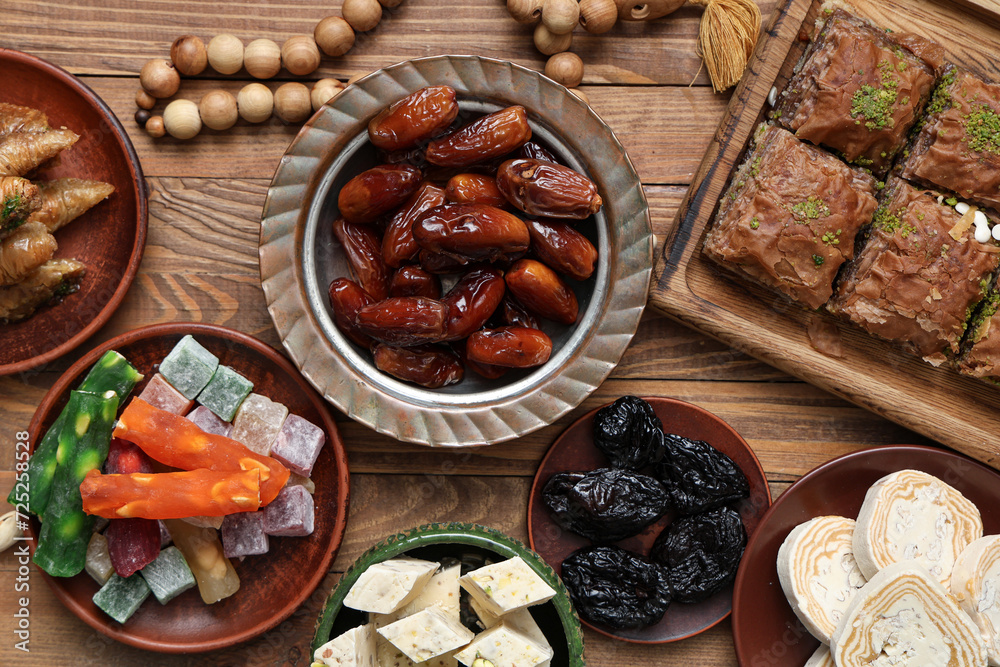 Composition with traditional Eastern sweets and tasbih for Ramadan on wooden table Composition with traditional Eastern sweets and tasbih for Ramadan on wooden table