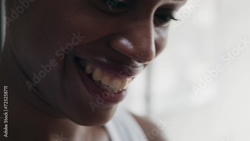 Black woman with short haircut smiling and shaking head in denial. Extreme closeup portrait of young female expressing disagreement. Concept of emotion photo