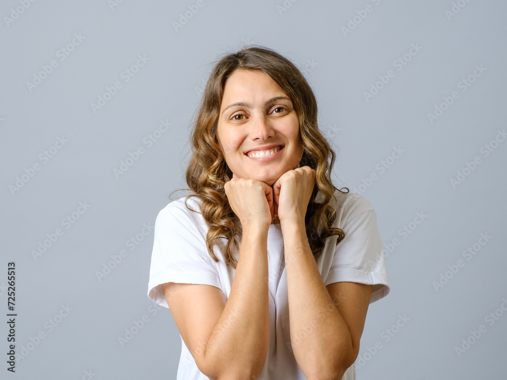 Portrait of a casual pretty young smiling woman thinking about something isolated Portrait of a casual pretty young smiling woman thinking about something isolated