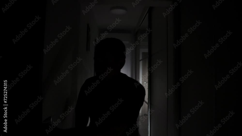 An Anxious Man is Searching for a Hiding Spot in the Dark House - Pullback Shot An Anxious Man is Searching for a Hiding Spot in the Dark House - Pullback Shot