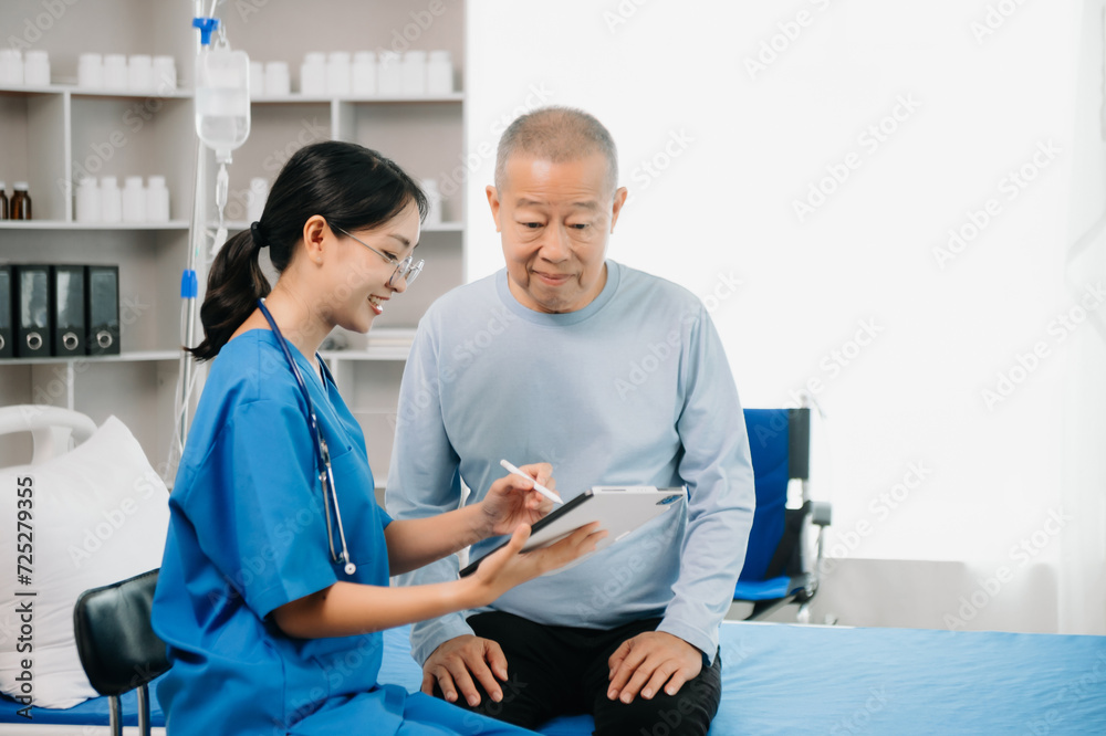 Senior Doctor discussing treatment with male patient talking and laughing sitting on examination bed Senior Doctor discussing treatment with male patient talking and laughing sitting on examination bed