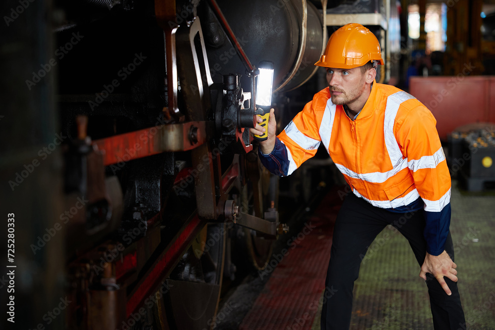 engineer or technician using light stick and checking construction train at station engineer or technician using light stick and checking construction train at station