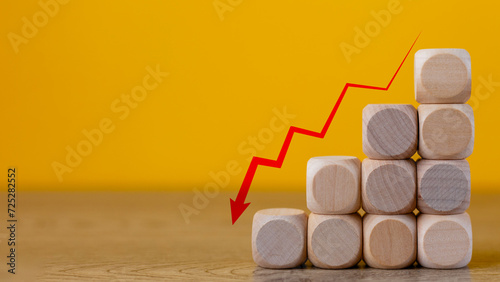 Business decrease concept abstract yellow background. Red arrow and wooden stairs bock.