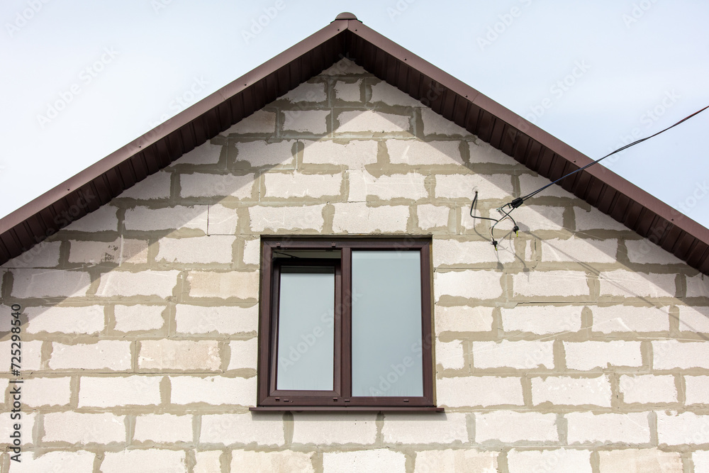 Window in the attic of a brick house Window in the attic of a brick house