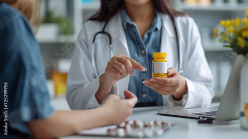 doctor is pointing to drug tablets and giving medicine to female patient at office healthcare, medical and pharmacy industry concept