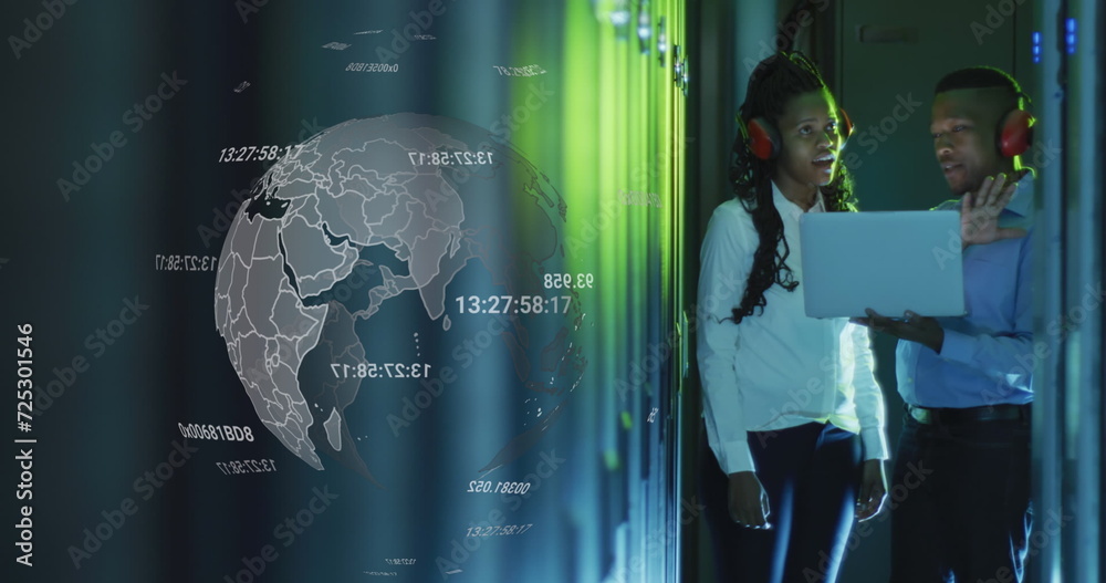 Obraz premium Image of globe over african american man and woman working with laptop and servers