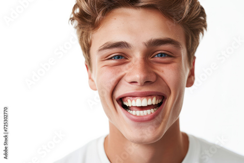 Joyful young man with bright smile on clean white background. Positive emotions.