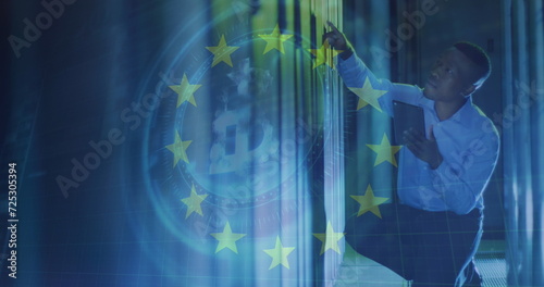 Image of eu flag over african american man using tablet in server room © vectorfusionart