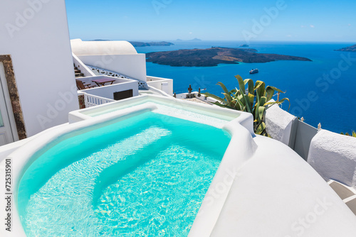 White architecture in Santorini island, Greece. Luxury swimming pool with sea view.
