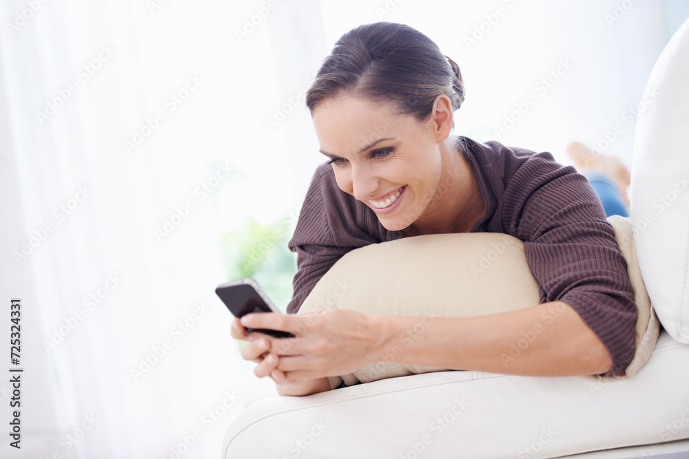 Woman, smile and typing with phone on sofa, scroll social media or reading chat notification in lounge at home. Happy lady, relax or download digital app, mobile games or search contact on smartphone Woman, smile and typing with phone on sofa, scroll social media or reading chat notification in lounge at home. Happy lady, relax or download digital app, mobile games or search contact on smartphone