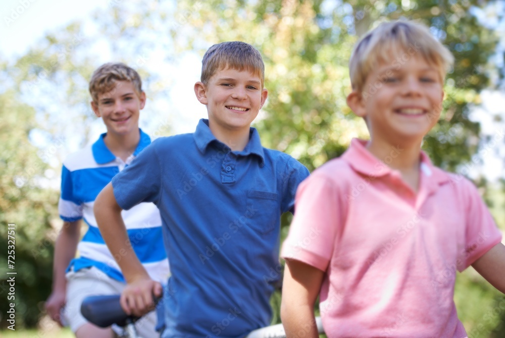 Fototapeta premium Nature, happy and kids with bicycle in park learning to ride for exercise in an outdoor forest. Smile, bonding and portrait of young boy children to cycle on bike for hobby in field, woods or garden.