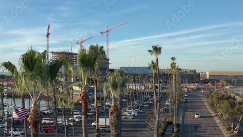 The new convention center being build in Chula Vista California, drone rising from behind palm trees. photo