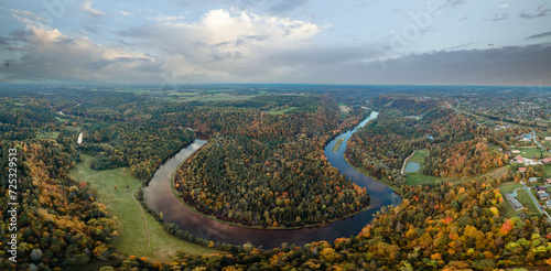 panoramic aerial view of the gauja river meandering through the colorful autumn landscape of sigulda, latvia, with the golden and crimson foliage of the gauja national park