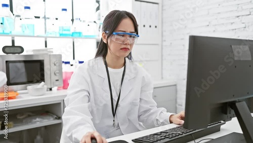 Disgusted young chinese woman scientist encounters intolerable stink at lab, unpleasant smell provokes strong dislike and unhappy expression photo