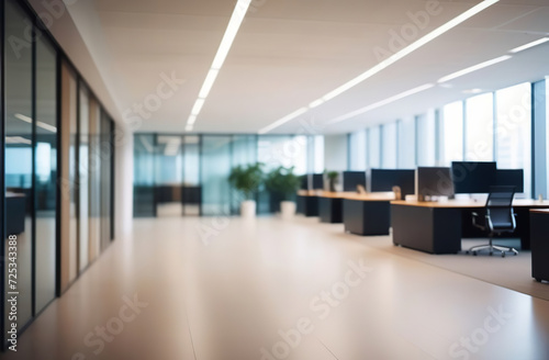Blurred empty modern office. Defocused abstract light bokeh business open space interior background for design. Corporate strategy  finance  operations  marketing. Blur focus of tables with computers
