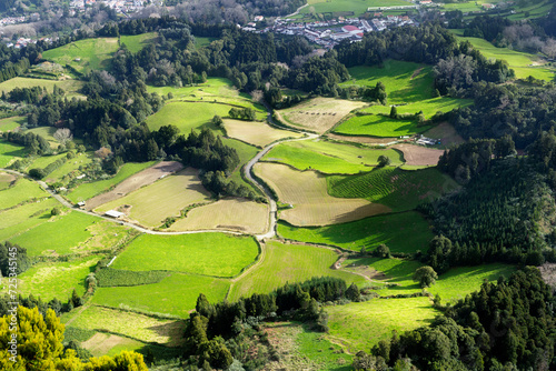 Panoramic green landscape with agricultural fields, hills and small village in Azores, Sao Miguel Island. Aerial view