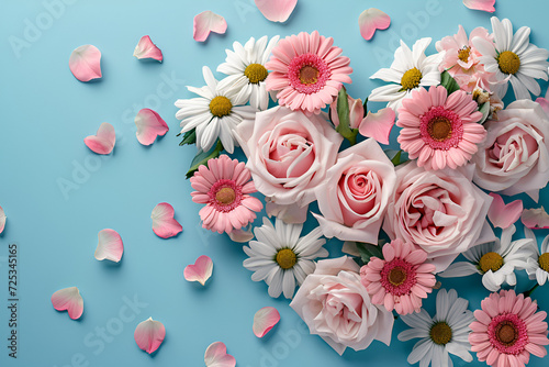 Pink dead roses make up a heart shaped arrangement on a white wooden background.