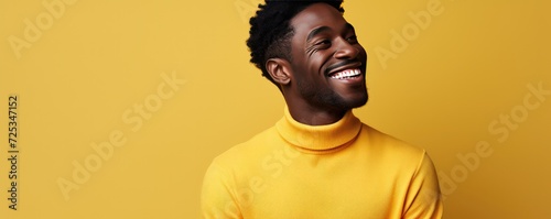 Handsome dark-skinned man in a yellow sweater on a dark background. Generative AI.