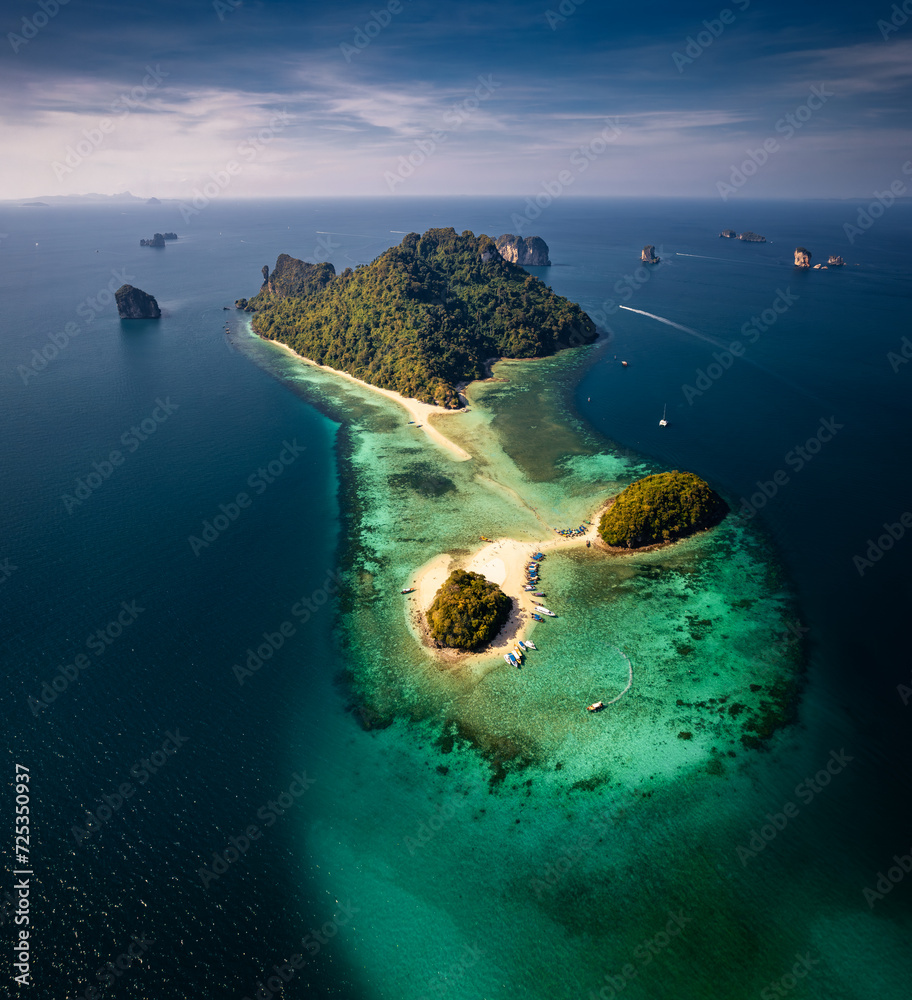 A breathtaking aerial view captures the pristine beauty of Krabi's enchanting island, adorned with turquoise waters and lush greenery