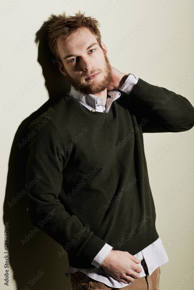 Fashion, portrait and young man in a studio with stylish, casual and trendy outfit for confidence. Serious, handsome and male person from Australia with cool style isolated by beige background. Fashion, portrait and young man in a studio with stylish, casual and trendy outfit for confidence. Serious, handsome and male person from Australia with cool style isolated by beige background.