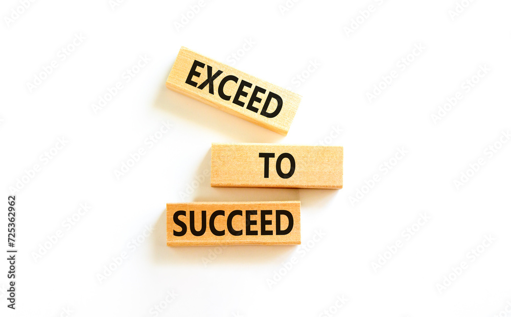 Exceed to succeed symbol. Concept words Exceed to succeed on beautiful wooden blocks. Beautiful white table white background. Business and exceed to succeed concept. Copy space. Exceed to succeed symbol. Concept words Exceed to succeed on beautiful wooden blocks. Beautiful white table white background. Business and exceed to succeed concept. Copy space.