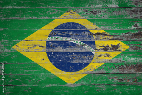 The national flag of Brazil is painted on uneven wooden  boards. Country symbol. photo