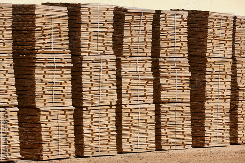 Cut and stacked pieces of wood. Industrial sawmill. Manufacture material