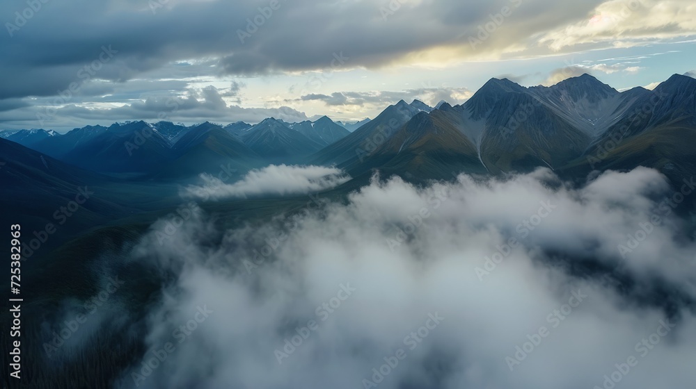 There's an aerial view of a mountain range with volumetric clouds and fog in the foreground.
