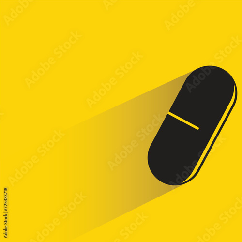 capsule with shadow on yellow background
