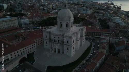 Drone shot over Nacional Pantheon in Lisbon with traffic and buildings around during blue hour photo