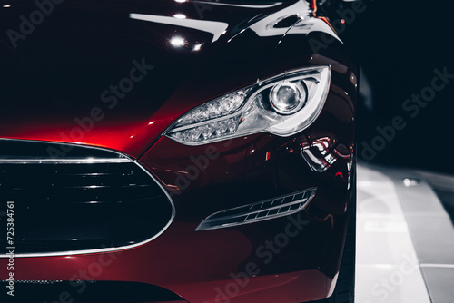 Close up shot of a headlight of a read car