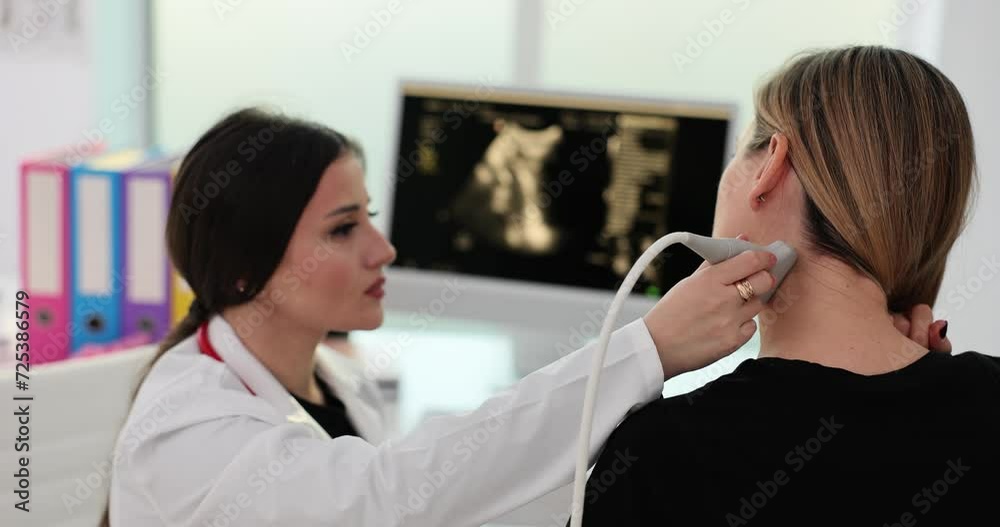 Doctor hands with a probe on a woman neck Doctor hands with a probe on a woman neck