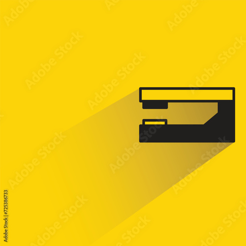 stapler icon with shadow on yellow background