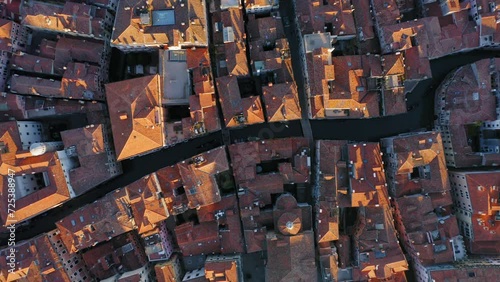 Top down view of canals with gondola and house roofs in the old town, Venice, Italy