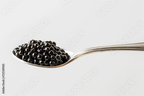 A spoonful of black caviar super close-up blank space for text white background